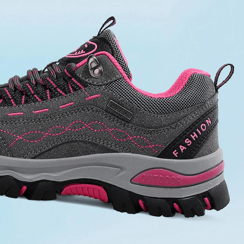 Gray and pink trekking women's sneakers with lace-up design, featuring a durable rubber outsole and comfortable synthetic lining.